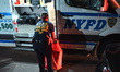 Investigators with the NYPD crime scene unit carry out several evidence bags from the home...