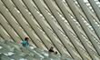 Two travelers stand at an upper level inside Liege-Guillemins train station in Liege, Belg...