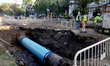 Crews work throughout the night into the next day to repair a 36'' water main that breaks,...