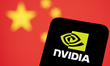 In this photographic illustration, the Nvidia logo appears on a smartphone with a flag of...