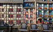 People walk across decorated bridges and observe the historic half-timbered houses and riv...