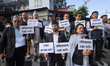Various professionals from Nepal display placards as they organize a rally in Kathmandu, N...