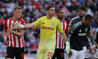 Emiliano Martinez of Aston Villa blocks Daniel Ballard of Sunderland during the Premier Le...