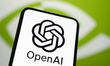 In this photo, the OpenAI logo appears on a smartphone with the Nvidia logo in the backgro...
