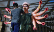 An artisan gives finishing touches to an idol of Goddess Durga at a workshop amid Durga Pu...