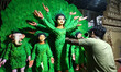 An artisan gives finishing touches to an idol of Goddess Durga at a workshop amid Durga Pu...