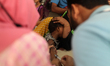 A child gives a blood sample for dengue testing as cases continue to rise in Bangladesh on...