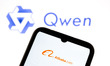 The Alibaba logo appears on a smartphone screen, and the Qwen logo appears as the backgrou...