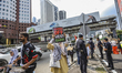 Protesters hold placards and walk towards the US embassy building during a protest against...
