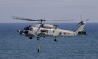 On September 26, 2025, in Busan, South Korea, the ROK Navy MH-60R descends a dipping sonar...
