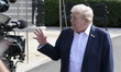 US President Donald Trump speaks to reporters before departing the White House en route to...