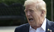 US President Donald Trump speaks to reporters before departing the White House en route to...