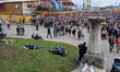 Visitors rest on the grass and steps after heavy drinking during Oktoberfest in Munich, Ba...