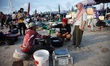 Fish traders serve customers at Kedonganan Fish Market in Kedonganan beach, Badung, Bali,...
