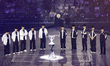 Gen.G and Hanwha Life Esports players bow to the crowd with the championship trophy placed...