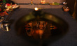An idol of the Hindu Goddess Durga is reflected on an oil lamp during the second day of wo...