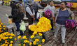 Residents of San Andres Mixquic in Mexico City, Mexico, buy cempasuchil flowers to go to t...