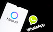 The Meta AI logo appears on a smartphone screen, and the WhatsApp logo serves as the backg...