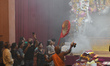 A Hindu priest performs aarti inside a pandal during the Durga Puja festival celebration i...