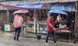 Daily life continues in a rural market despite heavy monsoon rain in Feni, Bangladesh, on...