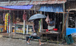 Daily life continues in a rural market despite heavy monsoon rain in Feni, Bangladesh, on...