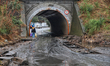 A woman walks on the side of a heavily waterlogged street in Odesa, Ukraine, on October 1,...