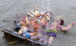 Hindu devotees immerse a clay idol of Goddess Durga in the Buriganga River on the final da...