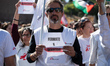 A person holds a placard reading ''Stop Genocide'' during a protest in solidarity with Pal...