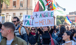A person holds a placard reading '+ Angurie - Meloni' during a protest in solidarity with...
