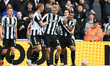 Nick Woltemade of Newcastle United celebrates with teammates after scoring a goal to make...
