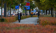 People ride electric scooters and bicycles on a bike path in Warsaw, Poland, on October 7,...