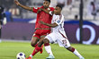 Assim Madibo of Qatar and Arshad Said Al-Alawi of Oman are in action during the FIFA World...