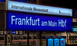 A view of the illuminated station sign ''Frankfurt am Main Hbf'' and passengers wait on a...