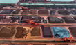 Large-scale machinery stacks and unloads iron ore at the Port of Xinsu in Lianyungang City...