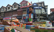 A vendor arranges firecrackers and waits for customers at a market ahead of Diwali, the Hi...