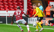Albert Adomah of Walsall pressures Elliot Newby of Barrow during the Sky Bet League 2 matc...