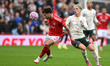 Neco Williams of Nottingham Forest wins the ball from Alejandro Garnacho of Chelsea during...