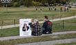 A person holds a sign while demonstrators take part in a protest against the Donald Trump...