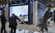 Military officials and visitors from various countries tour the Lockheed Martin booth duri...