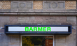 A sign of a Barmer health insurance branch is on a historic sandstone building in Schwabac...