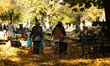 In Krakow, Poland, on October 23, 2025, people clean graves at Rakowicki Cemetery during p...