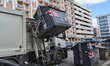 A garbage truck collects unsorted urban waste. The editorial image shows a garbage truck d...
