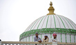 Nepalese Muslim glancing from roof to offer ritual prayer at Kashmari Jame mosque on the t...