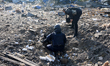 Rescuers search for the fragments of guided bombs at a civilian enterprise destroyed by a...