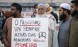 Several people hold protest signs against anti-burqa measures during a demonstration in Ro...