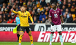Joao Gomes of Wolverhampton Wanderers points, and Lesley Ugochukwu of Burnley FC checks th...