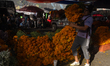 Vendors at the Jamaica market offer cempasuchil flowers to decorate offerings for the Day...