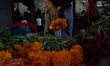 Vendors at the Jamaica market offer cempasuchil flowers to decorate offerings for the Day...