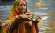 Hindu women perform rituals during the religious festival of Chhath Puja in Kolkata, India...