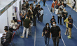 Job seekers look for company booths at the 2025 Job Fair at the Ken Arok Sports Hall in Ma...